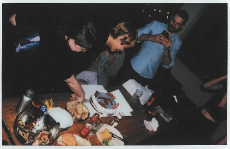 femtasy team members cut cake with femtasy logo